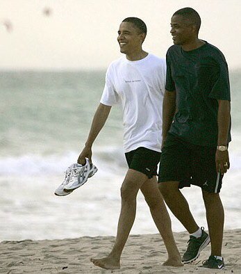 Obama and Reggie Love walking on the beach