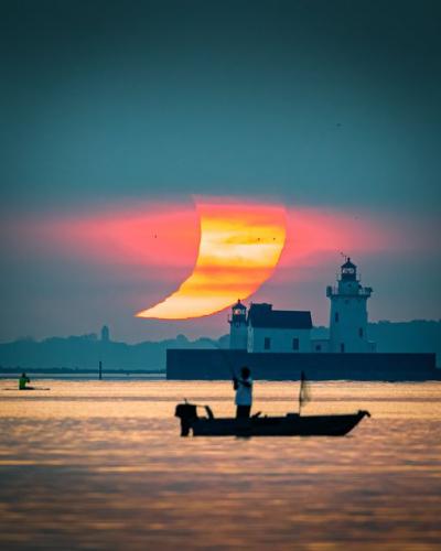 Solar eclipse over West Pierhead Lighthouse - Cleveland, OH