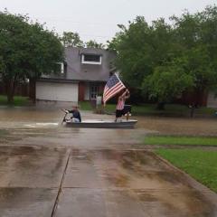 Louisiana Flood small boat carries the American flag