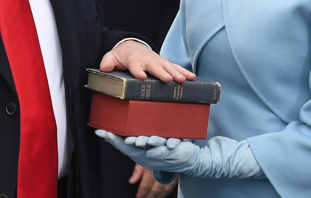 Trumps hand on the bibles held by Melania