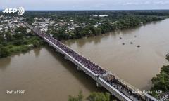 Migrants stack up on the bridge into Mexico after breaking through police barricades. Mexican border guards blocking their progress for now Oct 2018