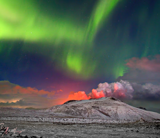 Auroras over an erupting volcano
