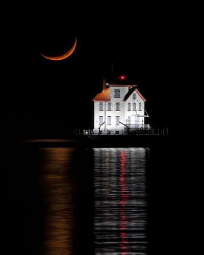 Crescent moon setting over Lorain, Ohio, Lighthouse
