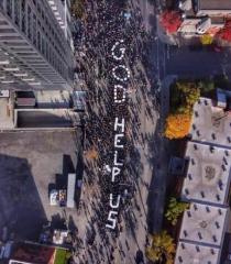 March in Montreal on Oct 31 21 spells out God Help Us